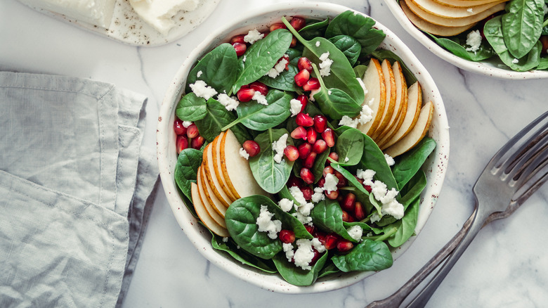 Spinach salad with crumbled cheese