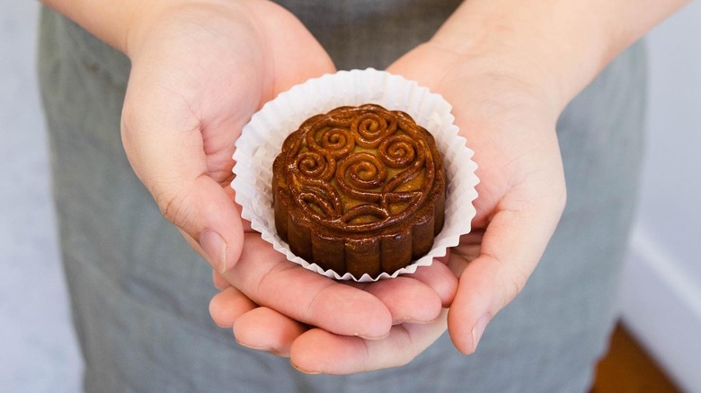 Holding a mooncake