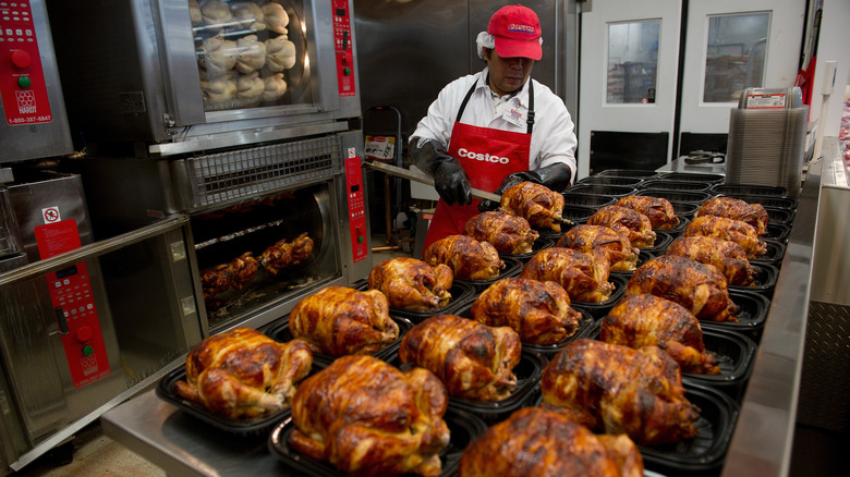 Costco employee packaging rotisserie chicken
