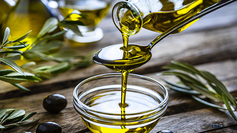 pouring olive oil in bowl