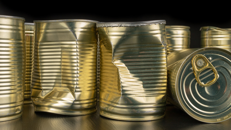 A lineup of dented cans