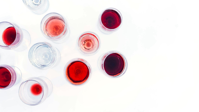 Glasses with different wine on a white background