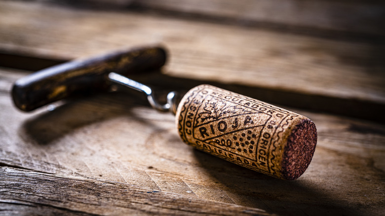 Rioja wine cork stopper shot on rustic wooden table