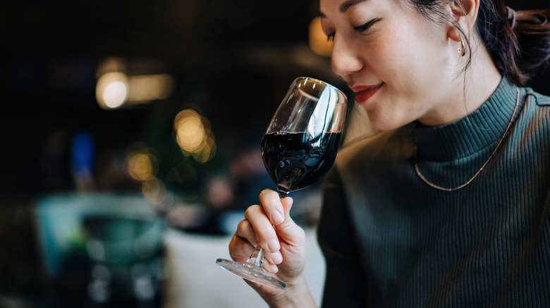 Woman drinking glass of red wine in a restaurant