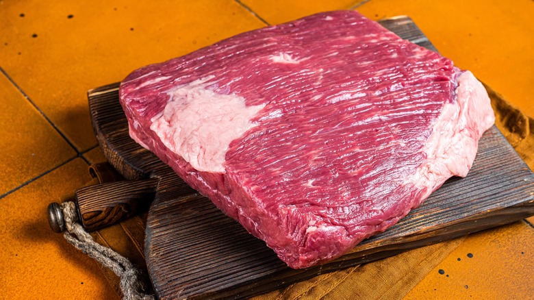 Raw beef brisket on wooden board 