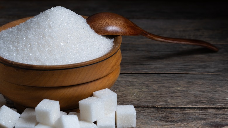 bowl of sugar alongside sugar cubes