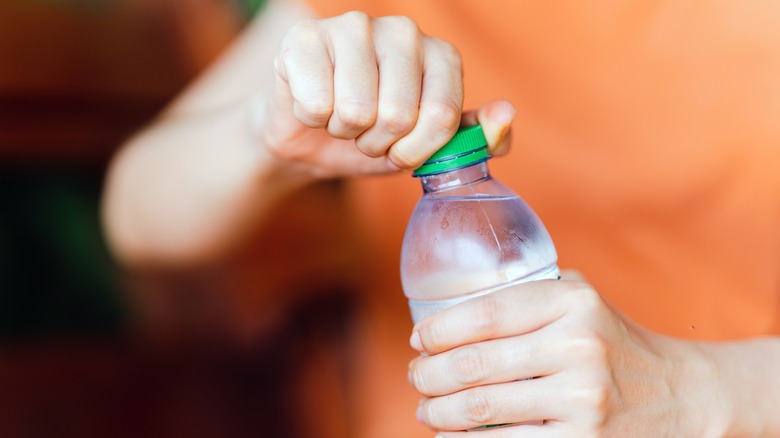 Person opening water bottle