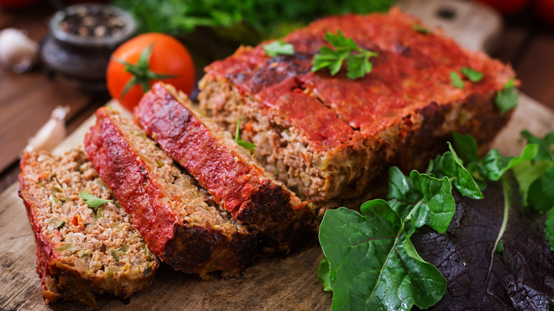 sliced classic meatloaf on cutting board