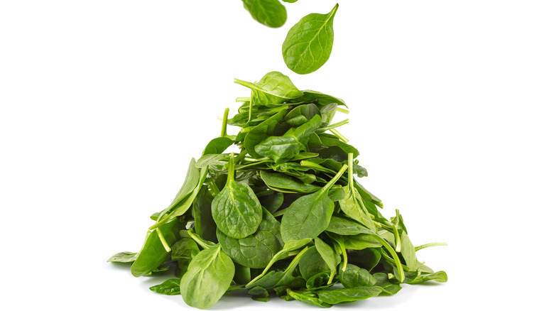 a pile of loose spinach leaves