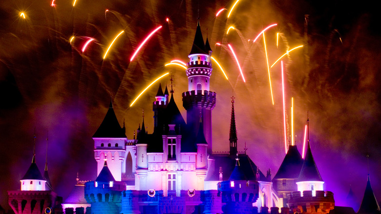 Disneyland castle at night with fireworks