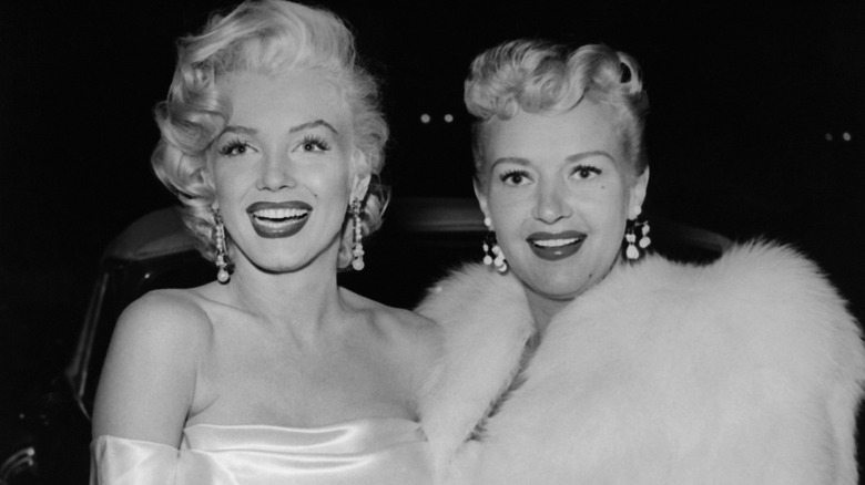 Marilyn Monroe smiling with Betty Grable at Ciro's in Hollywood