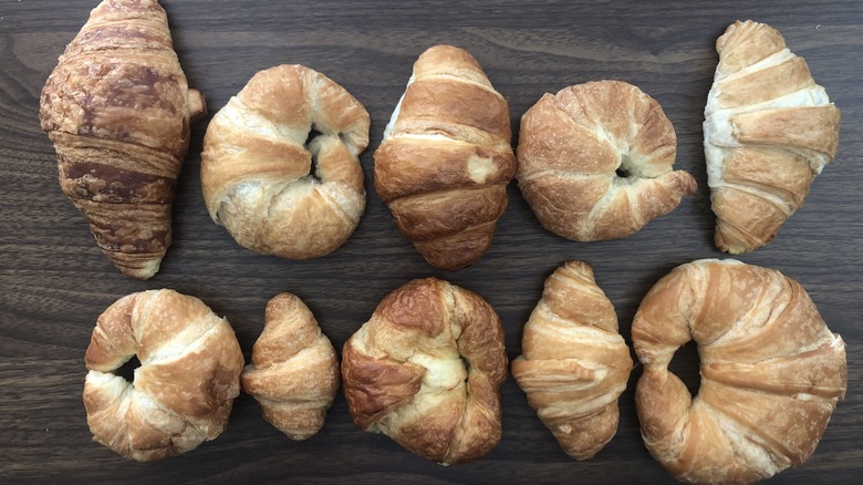 10 different store-bought croissants lined up in two rows.