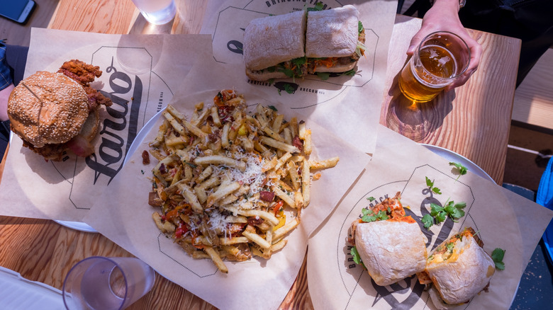 Lardo sandwiches and dirty fries on a table