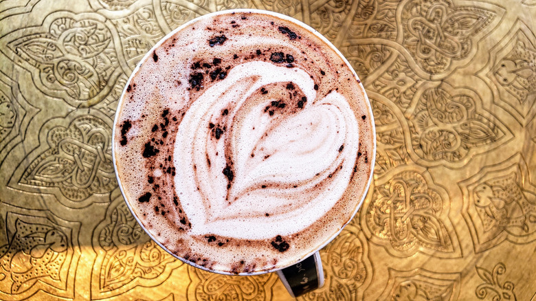 Rose mocha latte on a brass tray at Tov Coffee