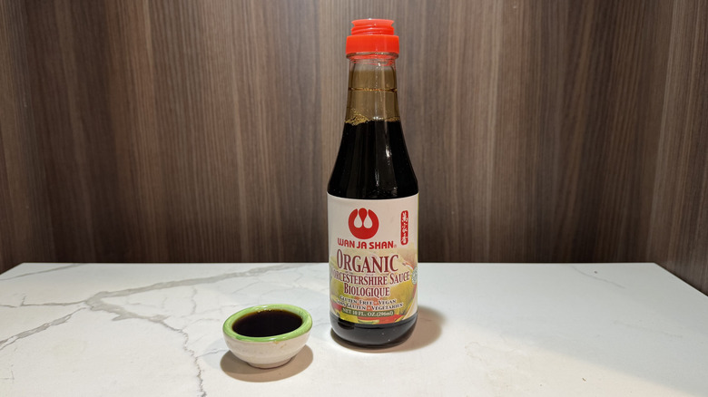 a bottle of wan ja shan worcestershire sauce and a thimble of sauce