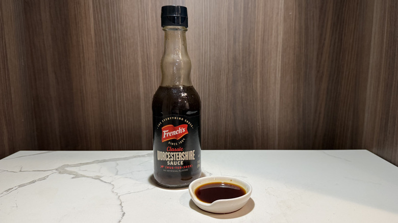 A bottle of French's Worcestershire Sauce and a dipping dish of sauce