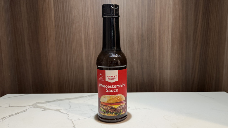 A bottle of Market Pantry brand Worcestershire sauce on marble surface