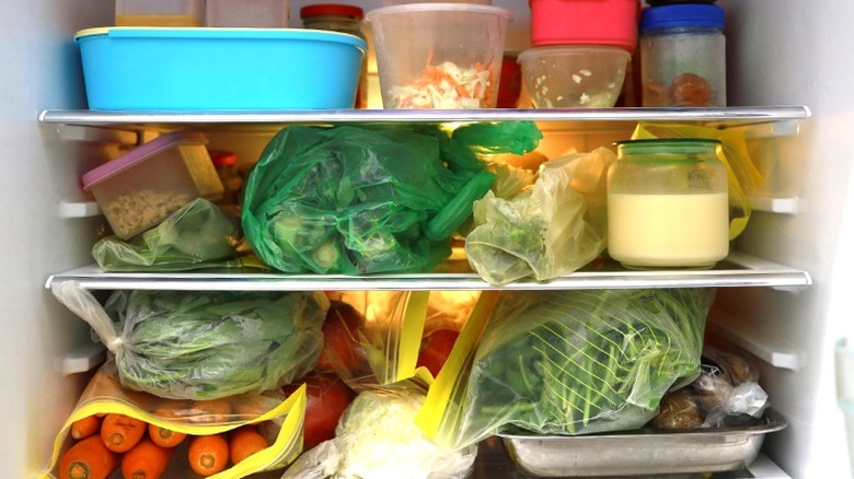 overstocked fridge with items