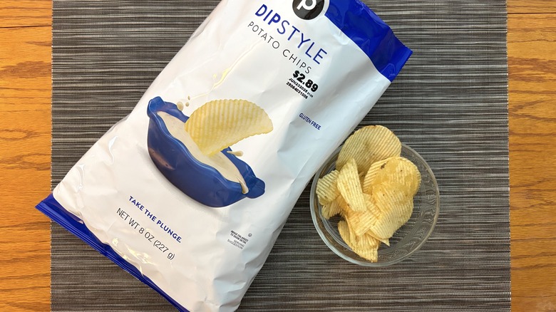 Publix dip style potato chips in bag and glass bowl on black placemat on wooden table in bag and glass bowl on black placemat on wooden table