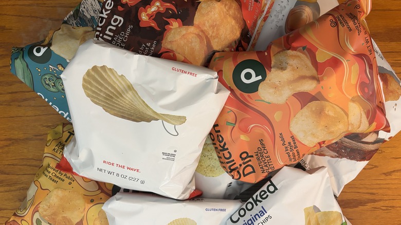 Various flavors of Publix potato chips on wooden table