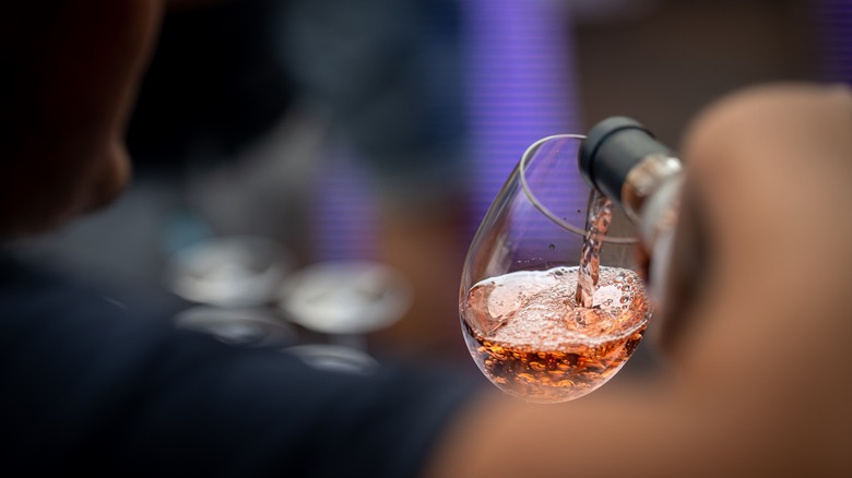 a glass of rosé being poured