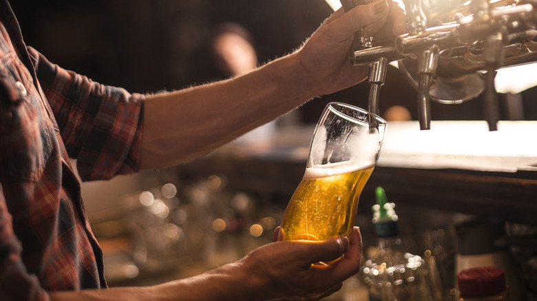 Bartender pouring beer from tap