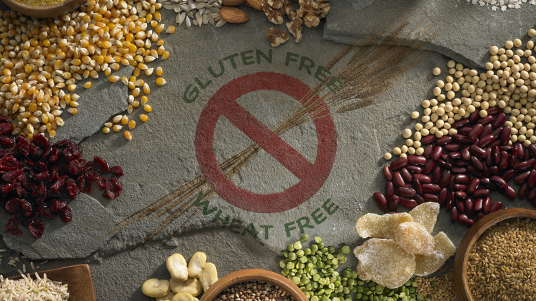 Concrete wall with a sign saying gluten free / wheat free in front of lots of different grains