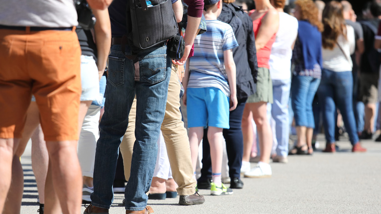 Queue of people waiting in line outside