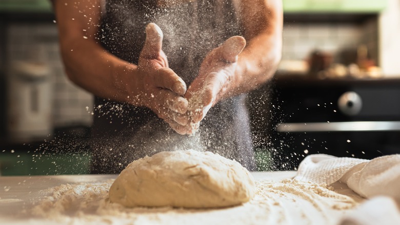 Floured hands with dough
