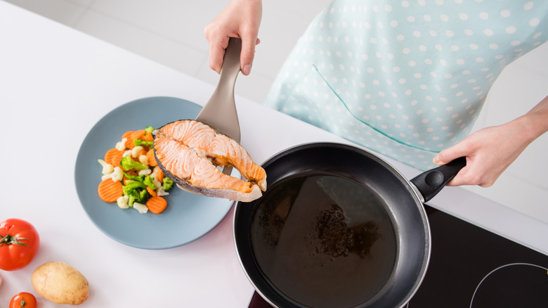 salmon grilling with pan and vegetables