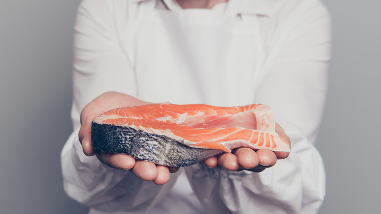 man holding salmon