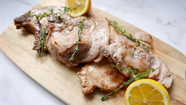 pork chops on cutting board