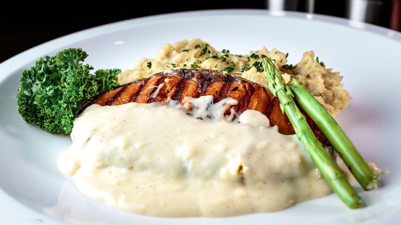 Tuna steak served with mashed potatoes and asparagus