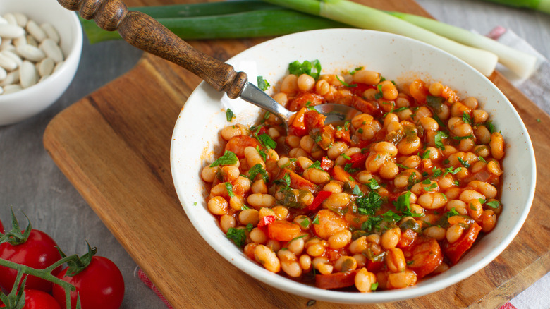 Bowl of rustic white bean and tomato stew spooned from a bowl