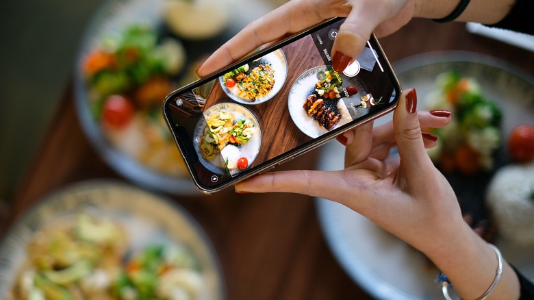 Woman taking picture of food