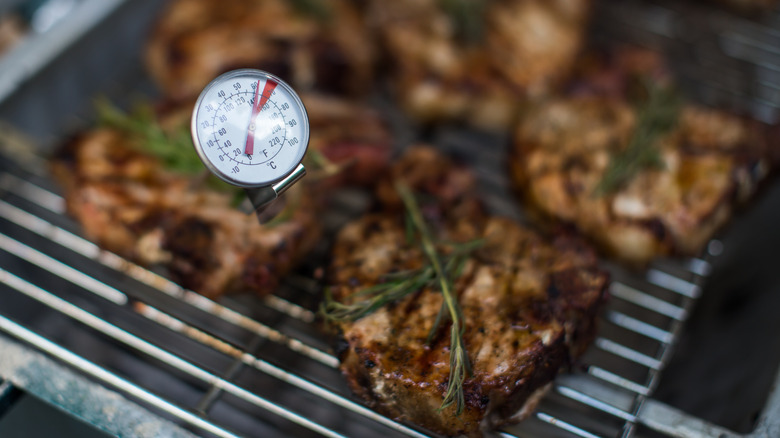 check steak temperature on grill with thermometer