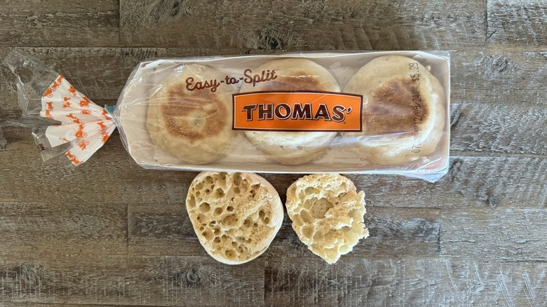 Thomas English muffins in and out of the package on a wooden table