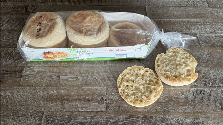 Nature's Promise English muffins in and out of the package on a wooden table