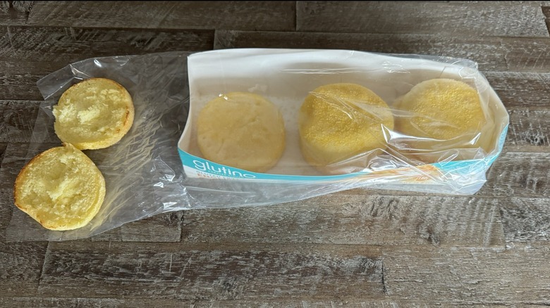 Glutino muffins in and out of the package on a wooden table