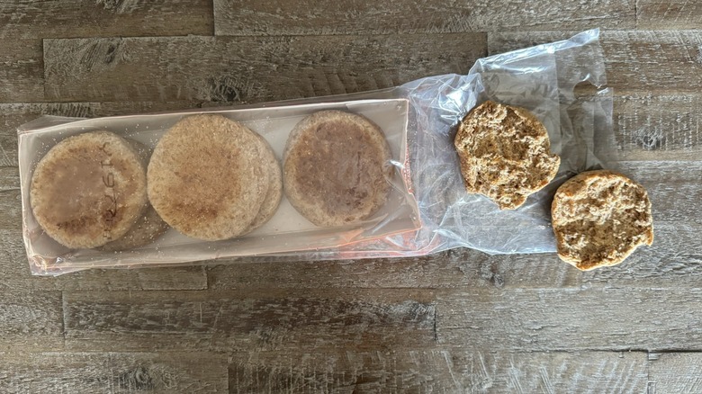 Ezekiel English muffins in and out of the package on a wooden table