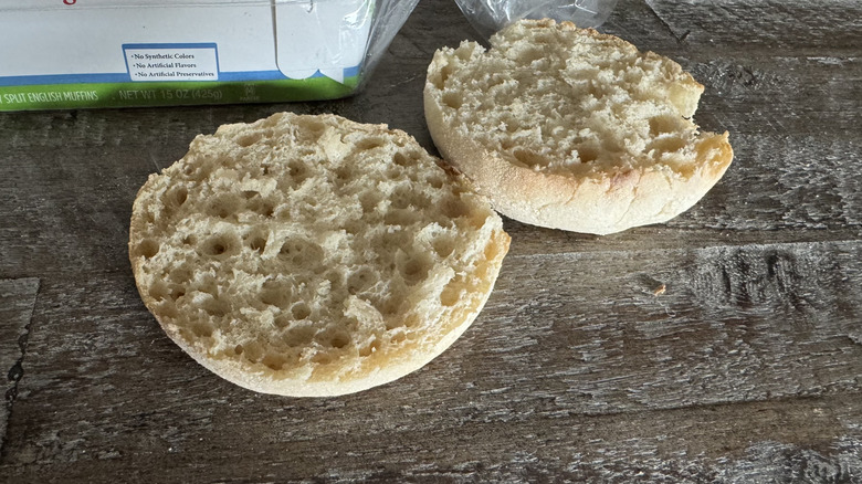 English muffins next to bag on wooden table