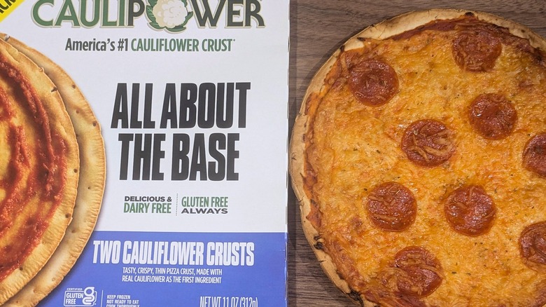 Caulipower brand pizza base box next to thin-crust pie with pepperoni