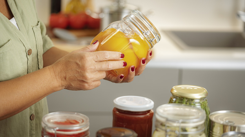 Woman holding jar of preserves