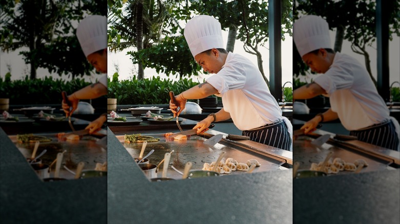 teppanyaki chef cooking on an outdoor grill