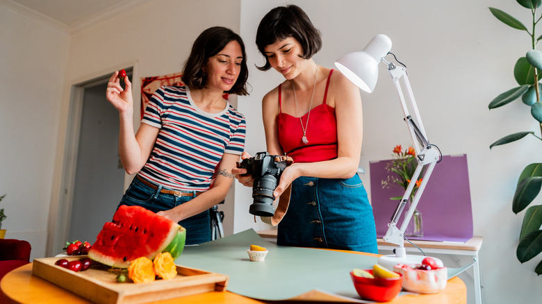 Team of two women working together on a food photoshoot