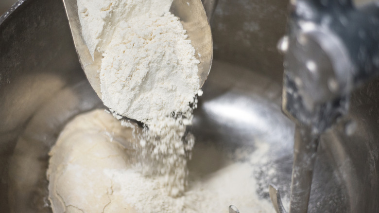 Flour being added to bowl