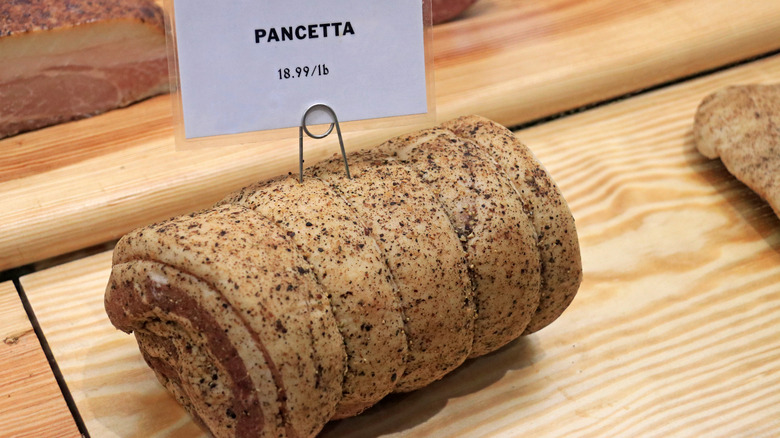 whole pancetta in store display case