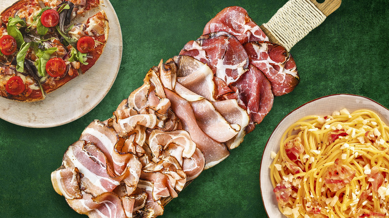 sliced pancetta on wooden cutting board with two dishes nearby