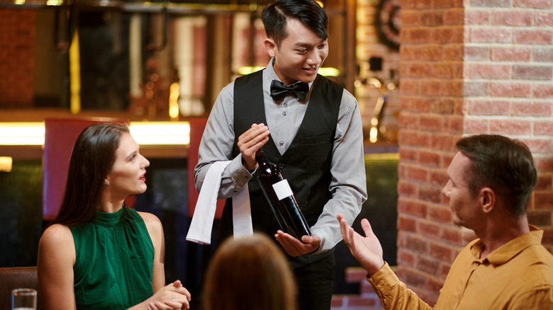 Sommelier presenting a bottle of wine