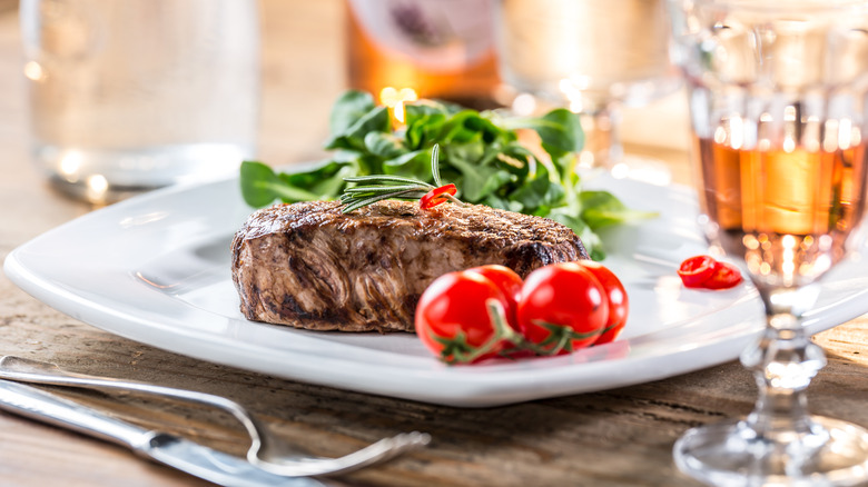 Glass of rose next to steak